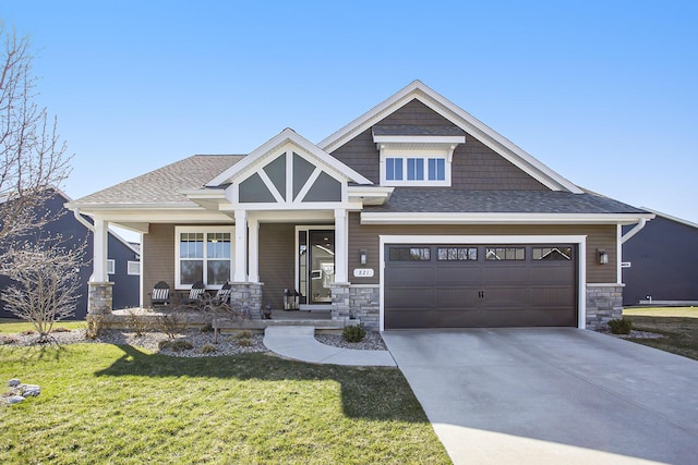 821 Janelle Ct, Portage, MI 49024 - craftsman house featuring a porch, a front lawn, driveway, stone siding, and an attached garage