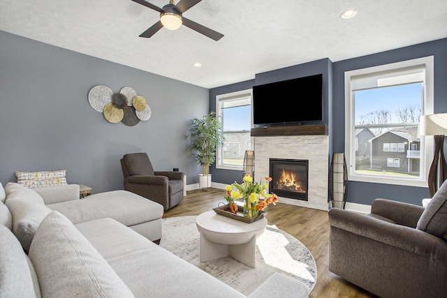 821 Janelle Ct, Portage, MI 49024 - living area featuring a ceiling fan, a tile fireplace, wood finished floors, baseboards, and recessed lighting