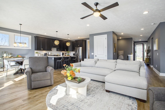 821 Janelle Ct, Portage, MI 49024 - living area with light wood finished floors, ceiling fan, recessed lighting, and baseboards