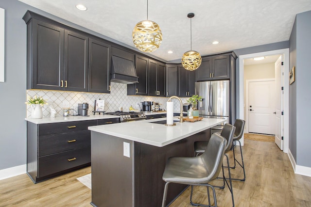821 Janelle Ct, Portage, MI 49024 - kitchen with premium range hood, a sink, stainless steel fridge, baseboards, and backsplash