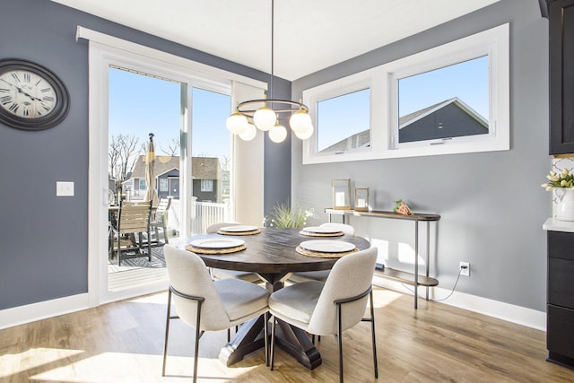 821 Janelle Ct, Portage, MI 49024 - dining space with baseboards, wood finished floors, and a chandelier