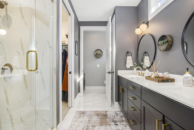 821 Janelle Ct, Portage, MI 49024 - bathroom with marble finish flooring, a stall shower, double vanity, baseboards, and a spacious closet