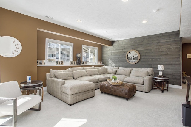 821 Janelle Ct, Portage, MI 49024 - living room featuring an accent wall, wood walls, carpet floors, baseboards, and recessed lighting