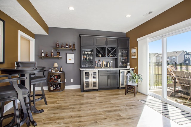 821 Janelle Ct, Portage, MI 49024 - indoor dry bar with light wood-style floors, wine cooler, recessed lighting, and baseboards
