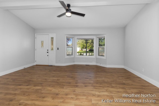 entrance foyer featuring a ceiling fan, wood finished floors, baseboards, and vaulted ceiling