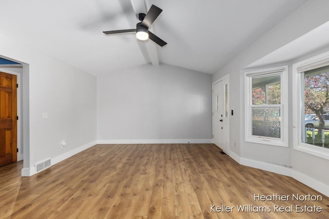 empty room featuring plenty of natural light, wood finished floors, ceiling fan, and baseboards