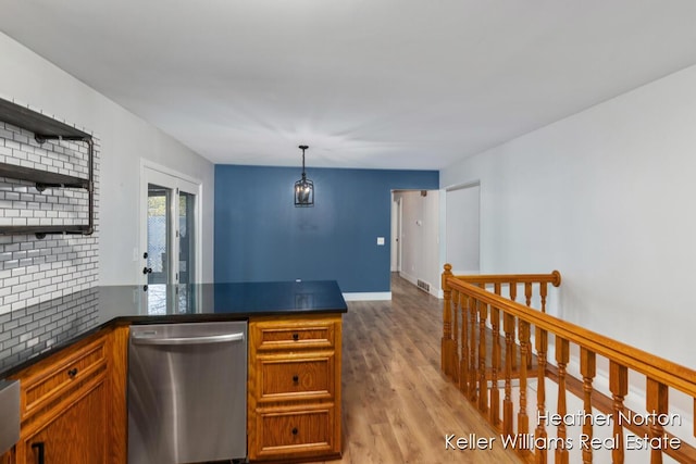 kitchen featuring dishwasher, a peninsula, light wood-style floors, open shelves, and dark countertops