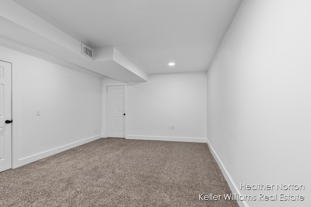 carpeted spare room featuring baseboards and recessed lighting