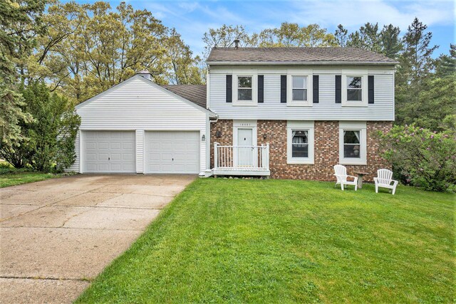 15467 Wisteria Ln, Spring Lake, MI 49456 - view of front of home featuring an attached garage, driveway, a front lawn, and brick siding