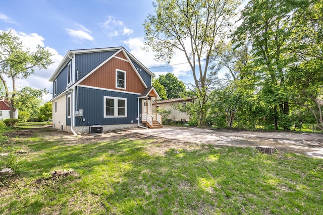 1435 Harpst St, Ann Arbor, MI 48104 - back of house with cooling unit and a lawn