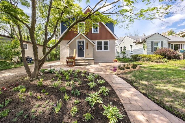 1435 Harpst St, Ann Arbor, MI 48104 - view of front of property with stucco siding and a front yard