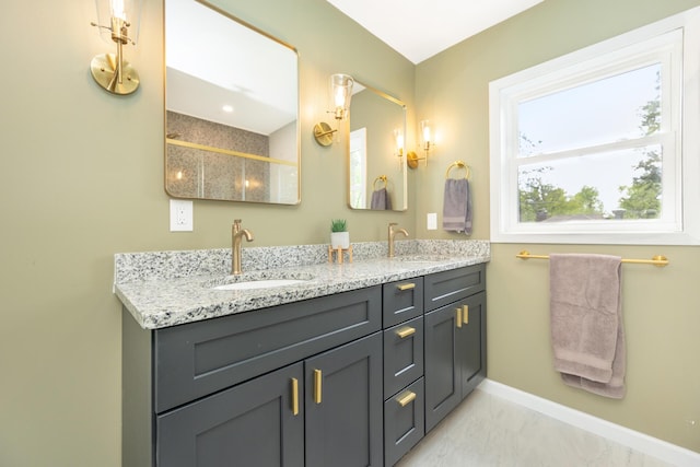 1435 Harpst St, Ann Arbor, MI 48104 - full bath featuring baseboards, double vanity, marble look tiles, and a shower