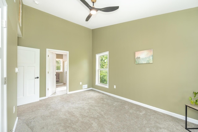 1435 Harpst St, Ann Arbor, MI 48104 - unfurnished bedroom with carpet, baseboards, ensuite bath, and ceiling fan