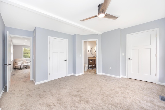 1435 Harpst St, Ann Arbor, MI 48104 - unfurnished bedroom featuring light carpet, connected bathroom, baseboards, beamed ceiling, and a ceiling fan