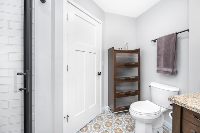 1435 Harpst St, Ann Arbor, MI 48104 - bathroom with toilet, baseboards, vanity, and tile patterned floors