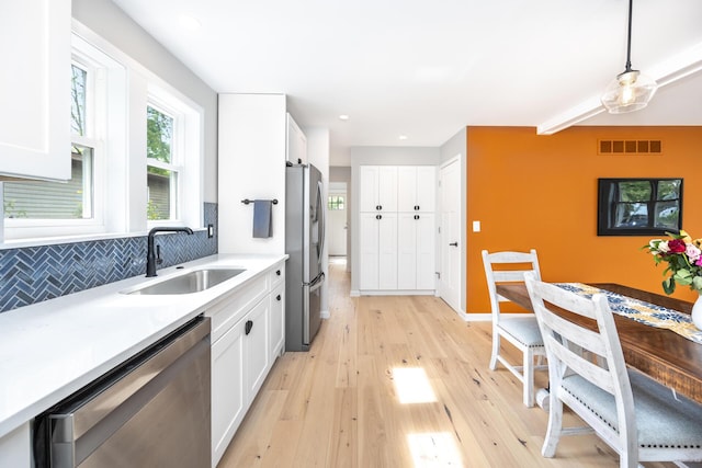 1435 Harpst St, Ann Arbor, MI 48104 - kitchen with stainless steel appliances, a sink, white cabinetry, light wood-style floors, and recessed lighting