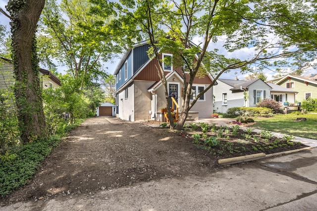 1435 Harpst St, Ann Arbor, MI 48104 - view of front of house featuring an outdoor structure and stucco siding