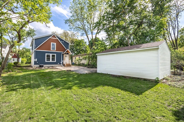 1435 Harpst St, Ann Arbor, MI 48104 - view of grassy yard with entry steps, an outdoor structure, a patio, and central AC unit