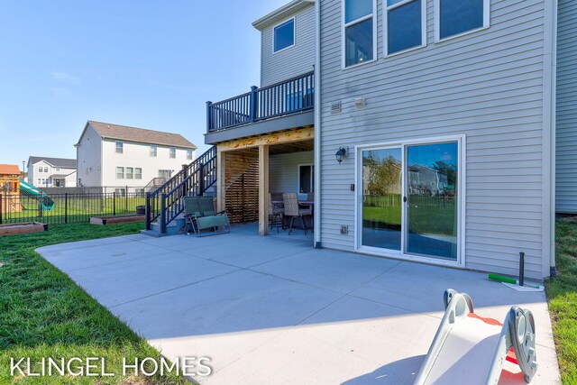 9235 Bigleaf Dr, West Olive, MI 49460 - back of property with a patio area, stairway, a deck, and fence