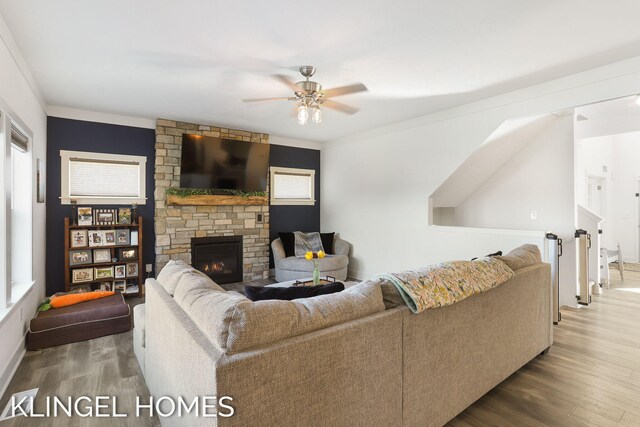 9235 Bigleaf Dr, West Olive, MI 49460 - living area with ceiling fan, wood finished floors, a fireplace, and healthy amount of natural light