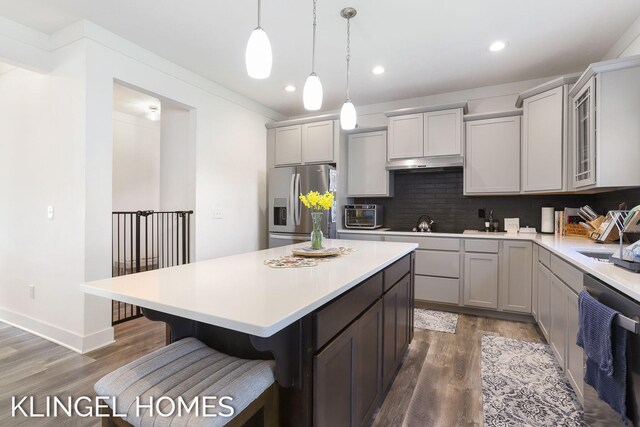 9235 Bigleaf Dr, West Olive, MI 49460 - kitchen with stainless steel refrigerator with ice dispenser, dishwasher, wood finished floors, light countertops, and recessed lighting