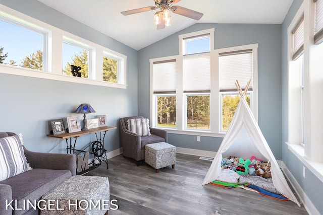 9235 Bigleaf Dr, West Olive, MI 49460 - sitting room with lofted ceiling, a ceiling fan, wood finished floors, and baseboards