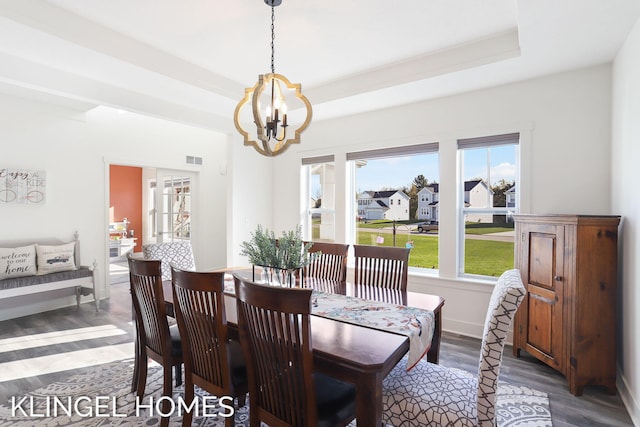 9235 Bigleaf Dr, West Olive, MI 49460 - dining room featuring wood finished floors, a chandelier, and a tray ceiling