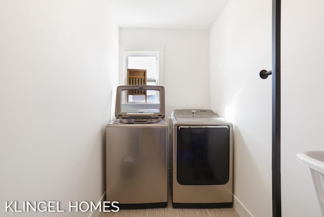 9235 Bigleaf Dr, West Olive, MI 49460 - washroom featuring washer and dryer and baseboards