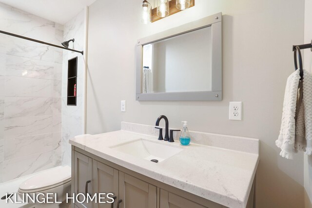 9235 Bigleaf Dr, West Olive, MI 49460 - bathroom featuring a shower, vanity, and toilet
