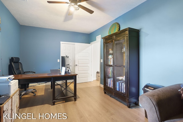 9235 Bigleaf Dr, West Olive, MI 49460 - office area featuring a ceiling fan, wood finished floors, and baseboards