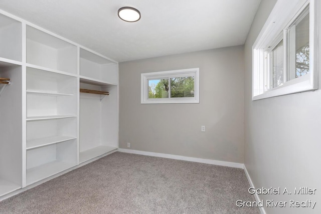 unfurnished bedroom with carpet flooring and baseboards