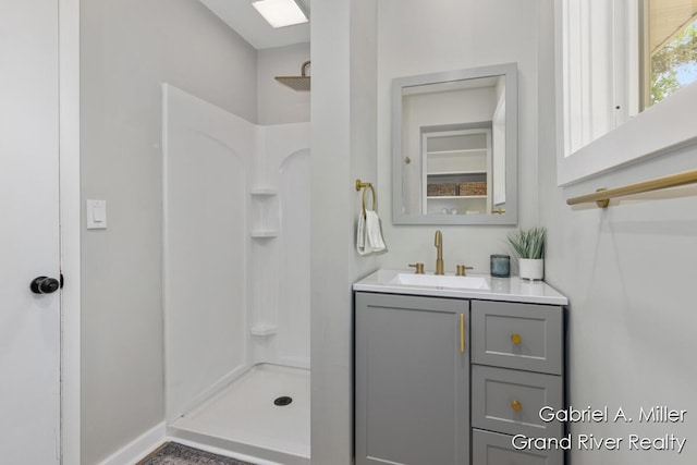 full bath featuring a shower and vanity