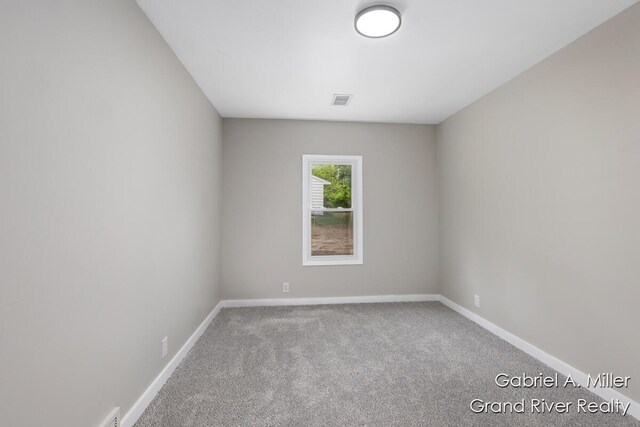 spare room with carpet flooring and baseboards