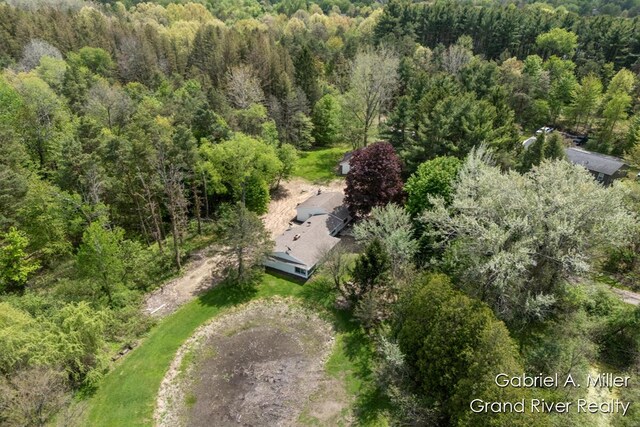 aerial view of property and surrounding area with a forest