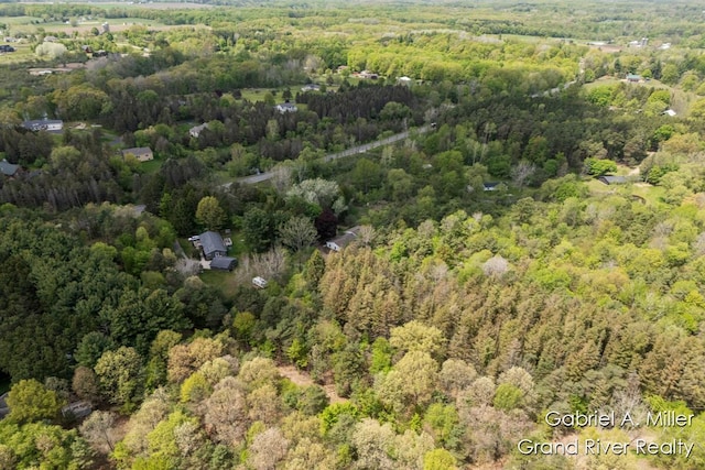aerial view of property and surrounding area with a forest