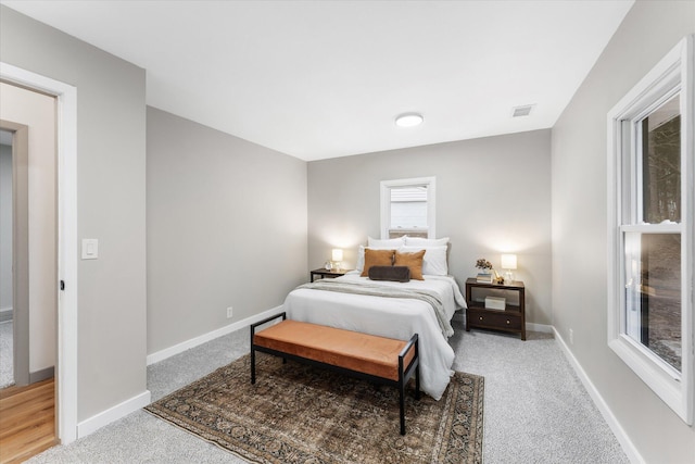 bedroom featuring carpet floors and baseboards