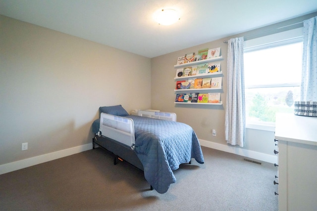 bedroom with carpet floors and baseboards