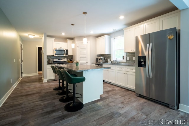 kitchen featuring appliances with stainless steel finishes, decorative backsplash, white cabinets, and recessed lighting