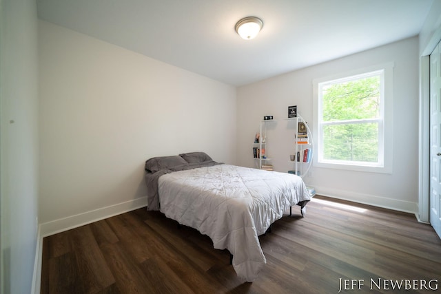 bedroom featuring dark wood-style floors and baseboards