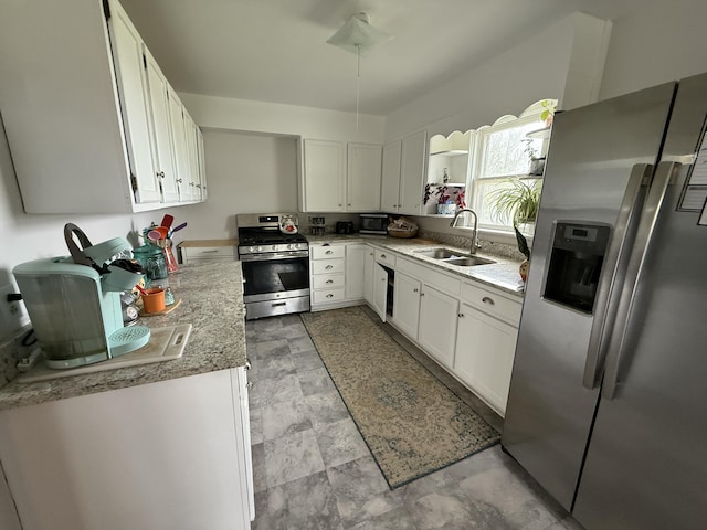 22011 Springer, Vicksburg, MI 49097 - kitchen featuring stainless steel appliances, a sink, white cabinetry, stone finish floors, and light countertops