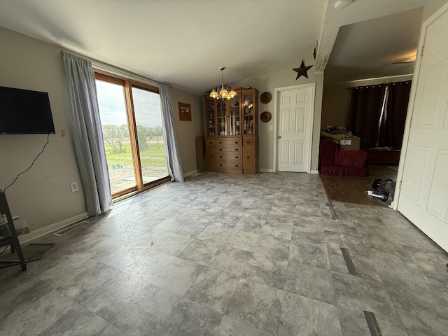 22011 Springer, Vicksburg, MI 49097 - unfurnished living room featuring a chandelier, lofted ceiling, baseboards, and stone finish flooring