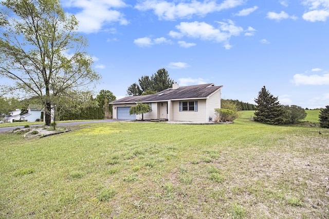 6001 Dover Ln, Traverse City, MI 49684 - view of front of property with an attached garage, a front lawn, a chimney, and asphalt driveway