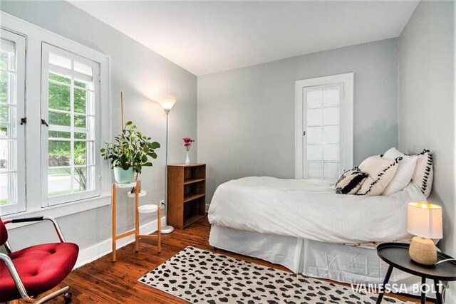 bedroom featuring dark wood-type flooring and baseboards