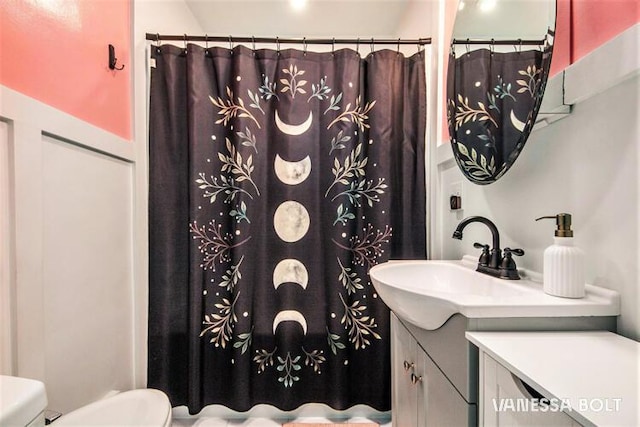 full bathroom with toilet, vanity, and a shower with curtain