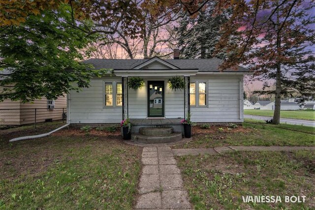 single story home featuring a chimney