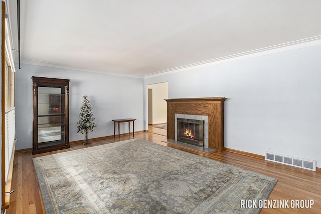 28 W 34th St, Holland, MI 49423 - living room with ornamental molding, a glass covered fireplace, wood finished floors, and baseboards