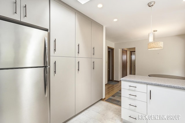 28 W 34th St, Holland, MI 49423 - kitchen featuring freestanding refrigerator, light countertops, pendant lighting, and recessed lighting