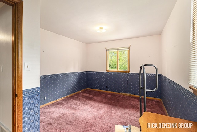 28 W 34th St, Holland, MI 49423 - spare room with carpet floors, a wainscoted wall, and wallpapered walls