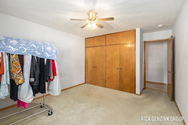 28 W 34th St, Holland, MI 49423 - unfurnished bedroom featuring carpet flooring, baseboards, a closet, and ceiling fan