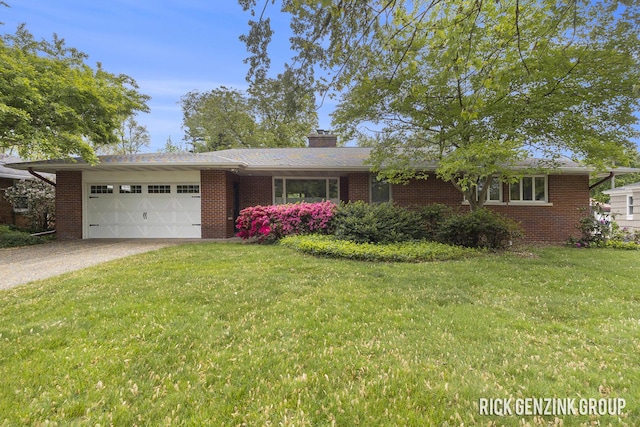 28 W 34th St, Holland, MI 49423 - single story home with a garage, brick siding, driveway, a front yard, and a chimney